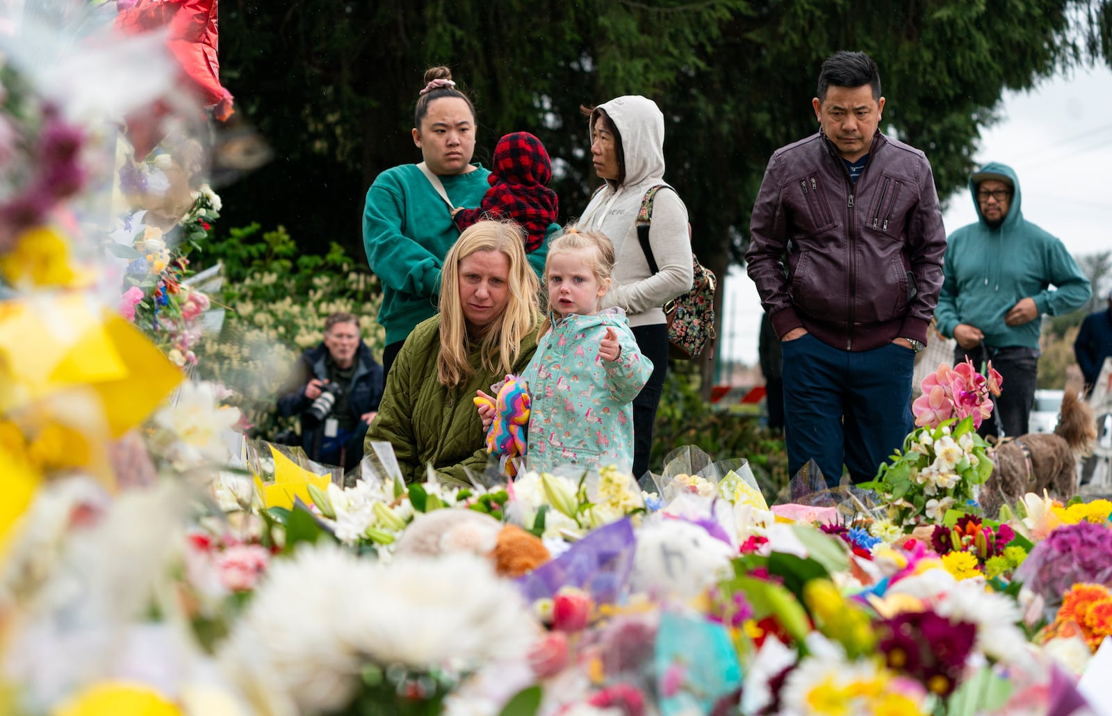 Mourners leaves flowers at a memorial site for the victims of an incident where a car drove through a crowd killing multiple people in Vancouver, British Columbia, Monday April 28, 2025. (Rich Lam/The Canadian Press via AP)
