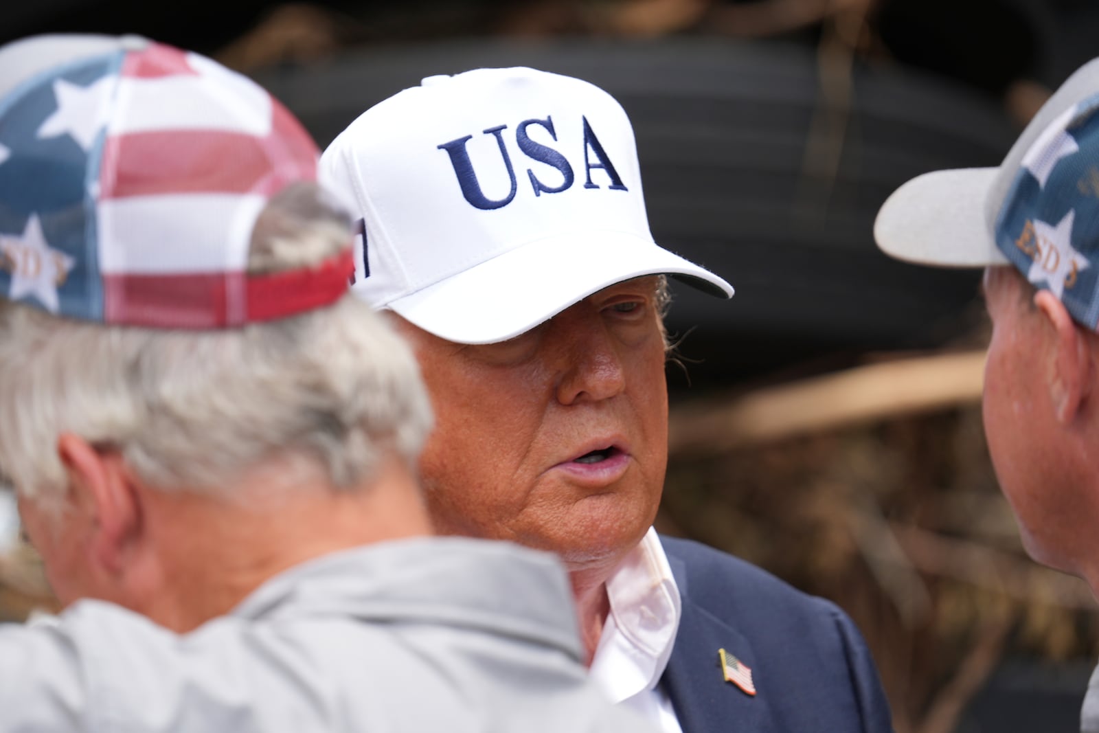 President Donald Trump, center, greets first responders as he observes flood damage in Kerrville, Texas, Friday, July 11, 2025. (AP Photo/Jacquelyn Martin)