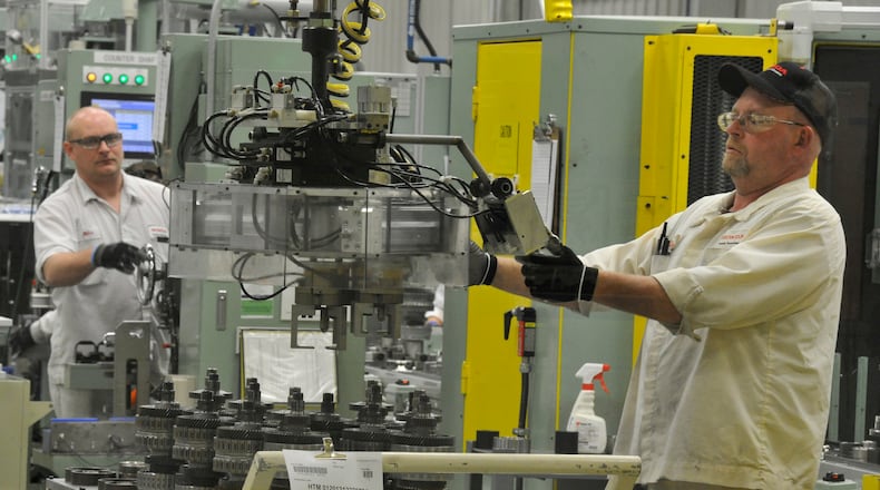 Honda associates work on the assembly line at the Honda Transmission Manufacturing plant in Russells Point in this 2013 file photo. Bill Lackey/Staff