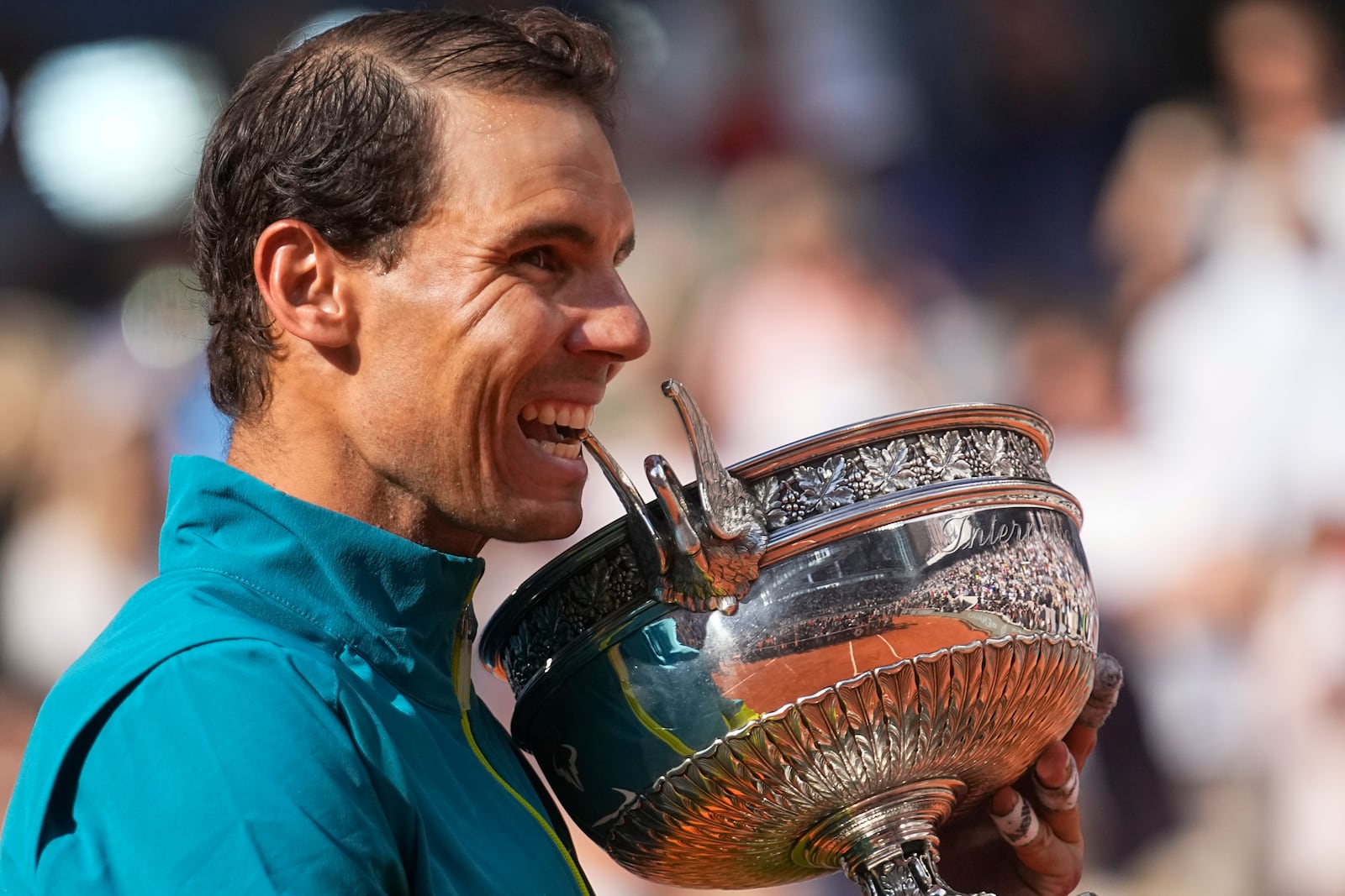 FILE - Spain's Rafael Nadal bites the trophy after winning the final match against Norway's Casper Ruud in three sets, 6-3, 6-3, 6-0, at the French Open tennis tournament in Roland Garros stadium in Paris, France, June 5, 2022. (AP Photo/Michel Euler, File)