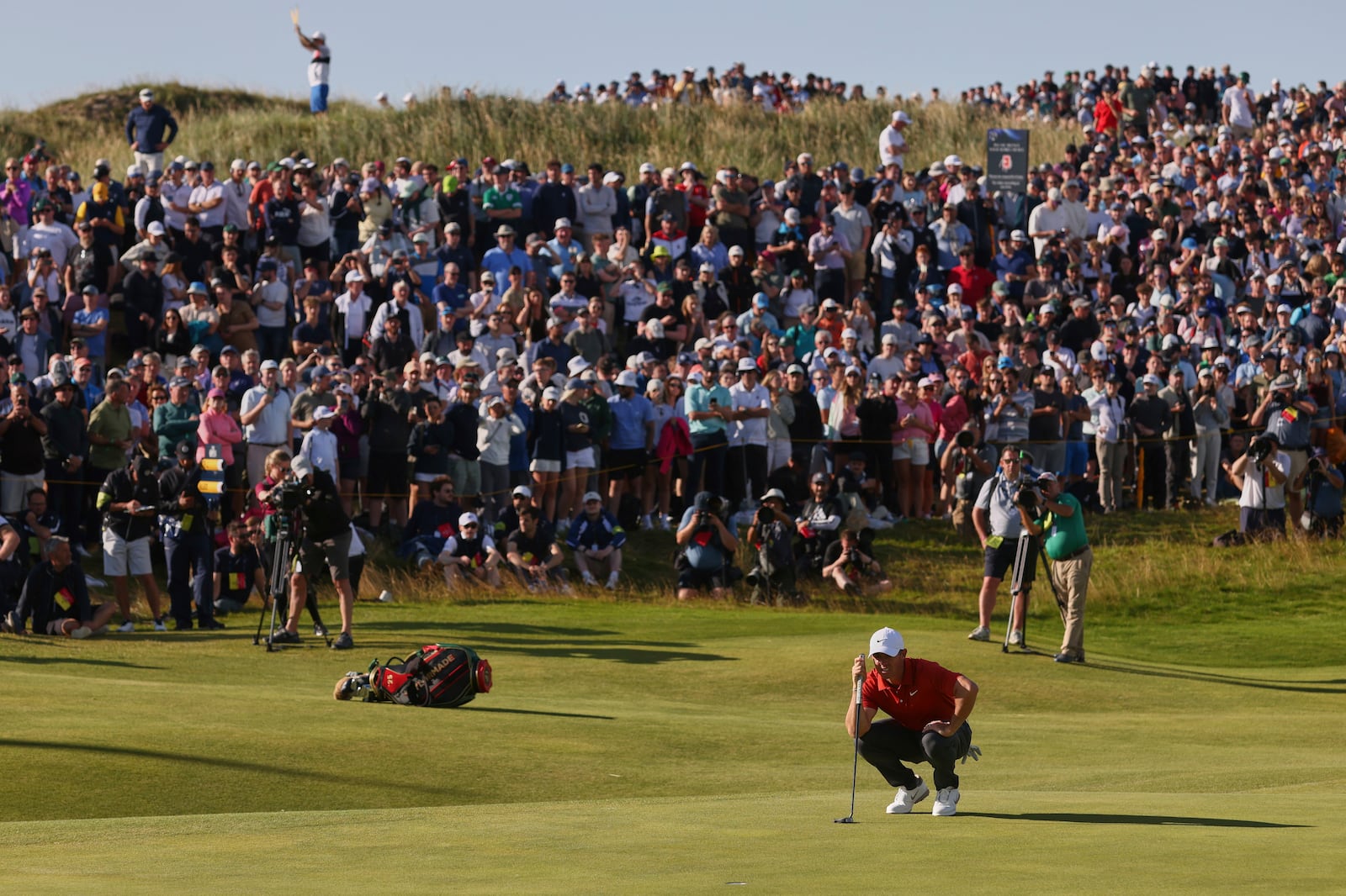 Rory McIlroy of Northern Ireland looks at the line of his putt on the 17th hole during the third round of the British Open golf championship at the Royal Portrush Golf Club, Northern Ireland, Saturday, July 19, 2025. (AP Photo/Peter Morrison)