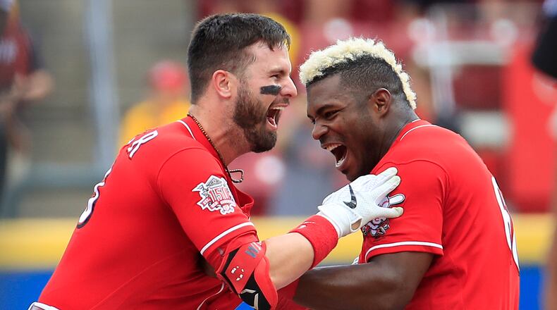 CINCINNATI, OHIO - JUNE 19: Jesse Winker #33 and Yasiel Puig #66 of the Cincinnati Reds celebrate after Winker hit a game winning RBI single in the 9th inning against the Houston Astros at Great American Ball Park on June 19, 2019 in Cincinnati, Ohio. (Photo by Andy Lyons/Getty Images)