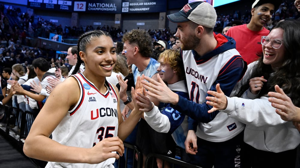 UConn guard Azzi Fudd (35) slaps hands with students at the end of a game against Syracuse in the second round of the NCAA college basketball tournament, Monday, March 23, 2026, in Storrs, Conn. (AP Photo/Jessica Hill)