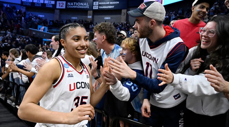 UConn guard Azzi Fudd (35) slaps hands with students at the end of a game against Syracuse in the second round of the NCAA college basketball tournament, Monday, March 23, 2026, in Storrs, Conn. (AP Photo/Jessica Hill)