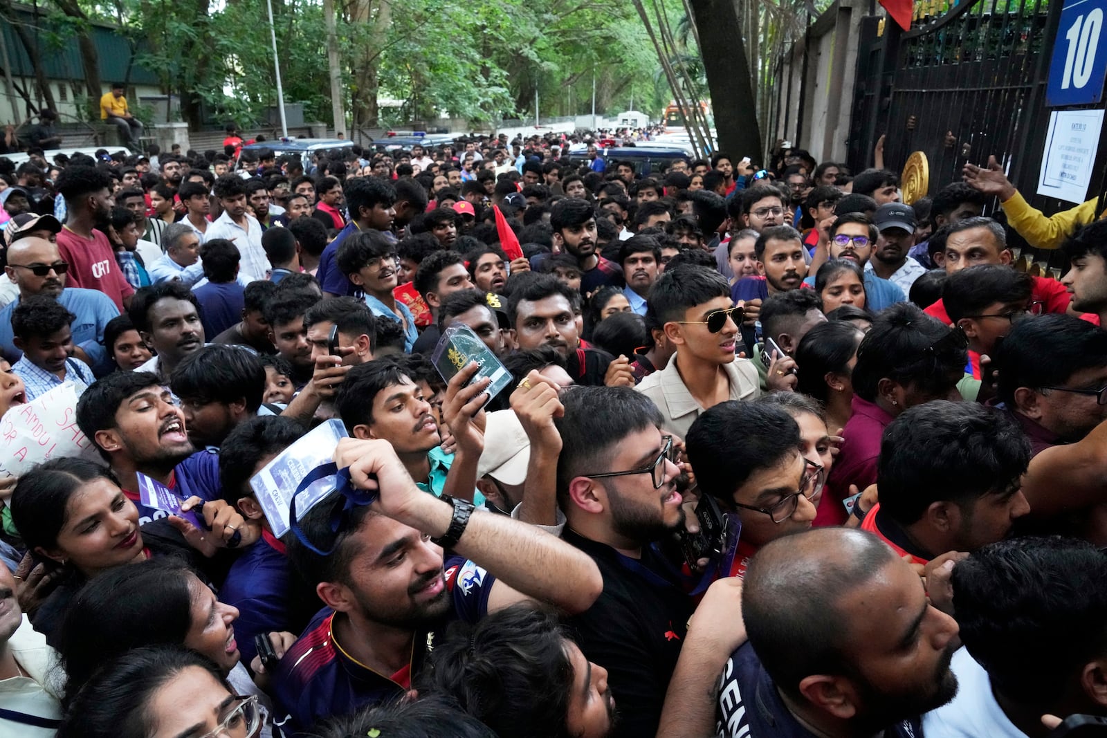 Fans wait to enter M. Chinnaswamy Stadium to celebrate Royal Challengers Bengaluru's victory in the Indian Premier League cricket tournament, in Bengaluru, India, Wednesday, June 4, 2025. (AP Photo/Aijaz Rahi)