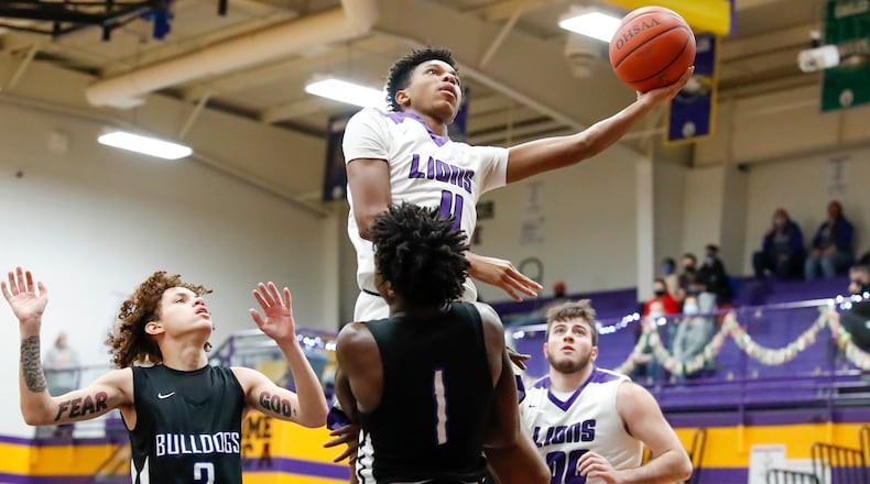 Emmanuel Christian Academy junior Justus Channels drives to the hoop against Yellow Springs' Malik Thomas during their game on Tuesday, Dec. 15. Channels and his brother Jason are two of the top scorers in the Metro Buckeye Conference this season. Michael Cooper/CONTRIBUTED