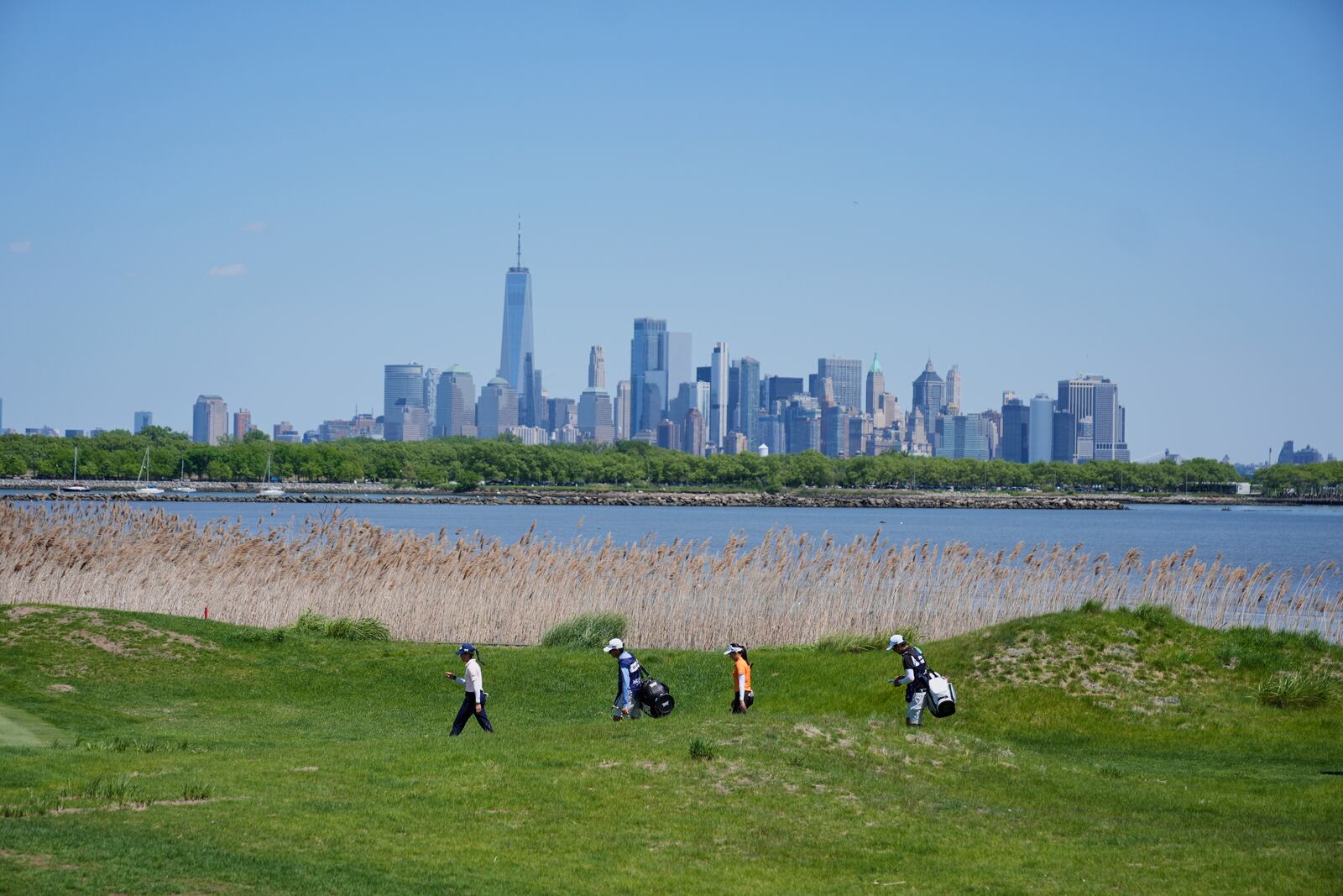 Jeeno Thitikul, of Thailand, second right, and Celine Boutier, of France, left, walk on the 14th hole during the final round of the Mizuho Americas Open LPGA golf tournament, Sunday, May 11, 2025, in Jersey City, N.J. (AP Photo/Seth Wenig)