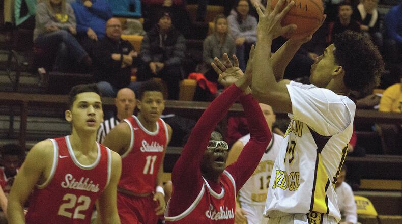 Kenton Ridge senior guard Nasiim McKay shoots over Stebbins’ Jalen Tolbert during Friday night’s game at Kenton Ridge. Jeff Gilbert/CONTRIBUTED