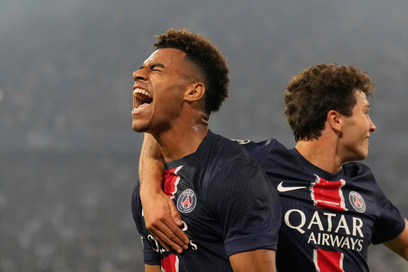 PSG's Desire Doue celebrates after scoring his side's second goal during the Champions League final soccer match between Paris Saint-Germain and Inter Milan at the Allianz Arena in Munich, Germany, Saturday, May 31, 2025. (AP Photo/Matthias Schrader)