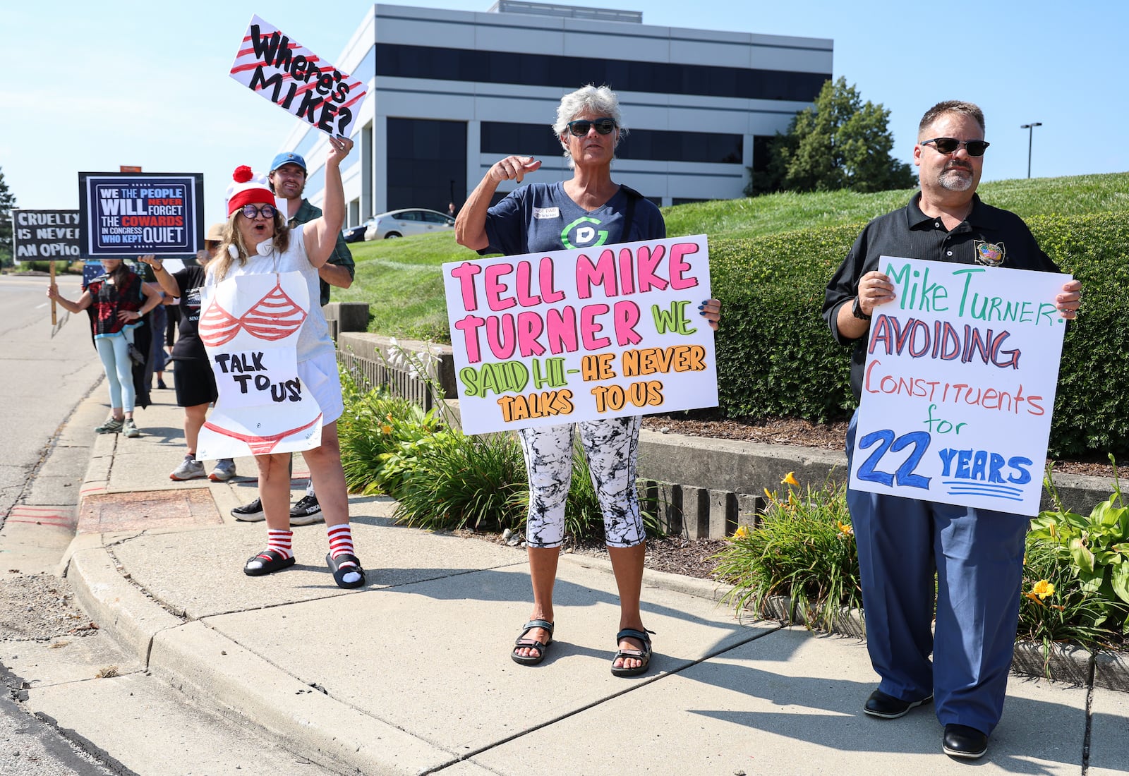 Demonstrators gathered on Thursday on the sidewalk along Center Park Boulverad in Fairborn near Wright State University in front of a DoubleTree by Hilton that U.S. Rep. Mike Turner (R-Dayton) was scheduled to speak at during a meeting with a defense trade group. Demonstrators were holding signs criticizing Turner for not hosting town halls or public meetings. BRYANT BILLING / STAFF
