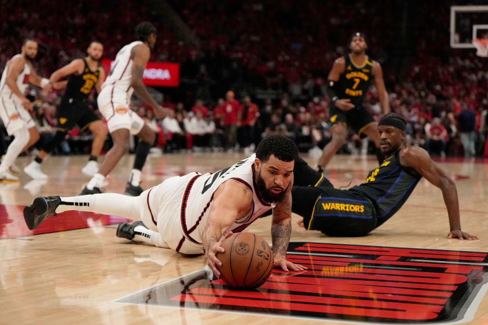 Houston Rockets' Fred VanVleet (5) reaches for a loose ball in front of Golden State Warriors' Jimmy Butler III during the second half of Game 7 of an NBA basketball first-round playoff series Sunday, May 4, 2025, in Houston. (AP Photo/Ashley Landis)
