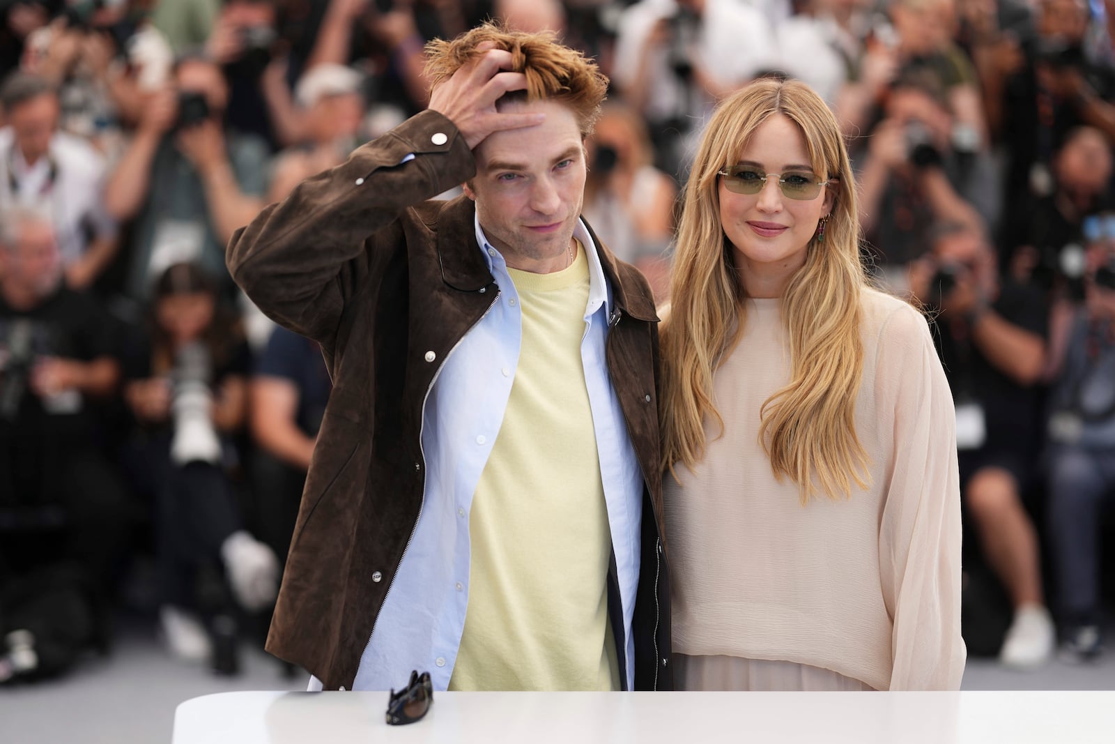 Robert Pattinson, left, and Jennifer Lawrence pose for photographers at the photo call for the film 'Die, My Love' at the 78th international film festival, Cannes, southern France, Sunday, May 18, 2025. (Photo by Scott A Garfitt/Invision/AP)