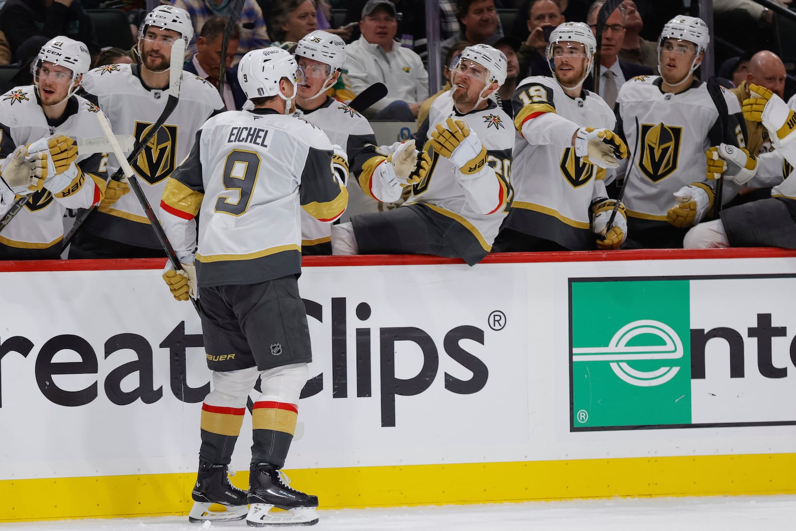 Vegas Golden Knights center Jack Eichel (9) is congratulated by teammates after scoring during the second period of Game 6 of a first-round NHL hockey playoff series against the Minnesota Wild, Thursday, May 1, 2025, in St. Paul, Minn. (AP Photo/Bailey Hillesheim)