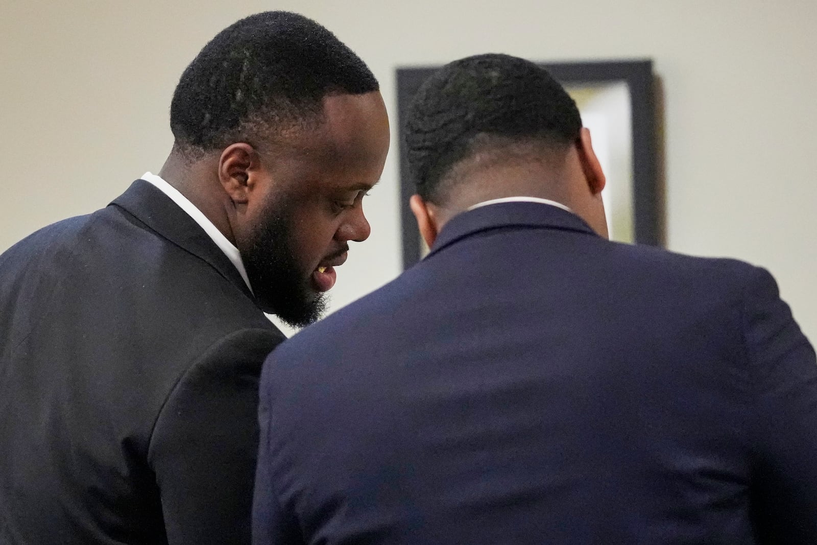 Former Memphis Police Officer Tedarrius Bean, left, one of three former Memphis officers charged with fatally beating Tyre Nichols in 2023, speaks to his attorney during his trial, Wednesday, April 30, 2025, in Memphis, Tenn. (AP Photo/George Walker IV, Pool)
