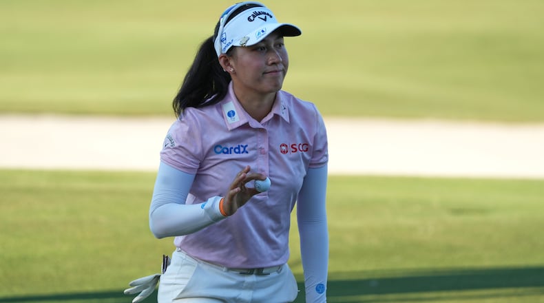 Jeeno Thitikul of Thailand shows her ball after making a birdie putt on the 17th hole during the second round of the LPGA Tour Championship golf tournament, Friday, Nov. 21, 2025, in Naples, Fla. (AP Photo/Marta Lavandier)
