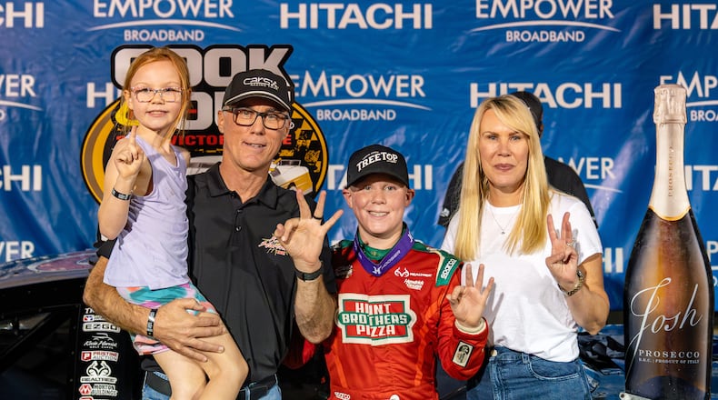 In this undated image provided by Kevin Harvick, Inc., Keelan Harvick, center, poses with his family, from left, sister Piper, father retired NASCAR driver Kevin Harvick and mother DeLana Harvick following a victory. (Adrenalens Media/Kevin Harvick, Inc. via AP)
