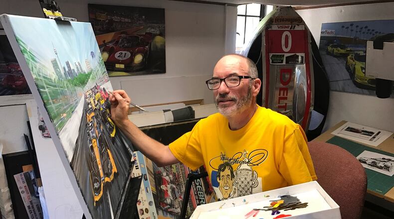 In the studio of his home in Hamilton, artist Roger Warrick works on a scene he painted from the Toronto Indy race. Tom Archdeacon/CONTRIBUTED