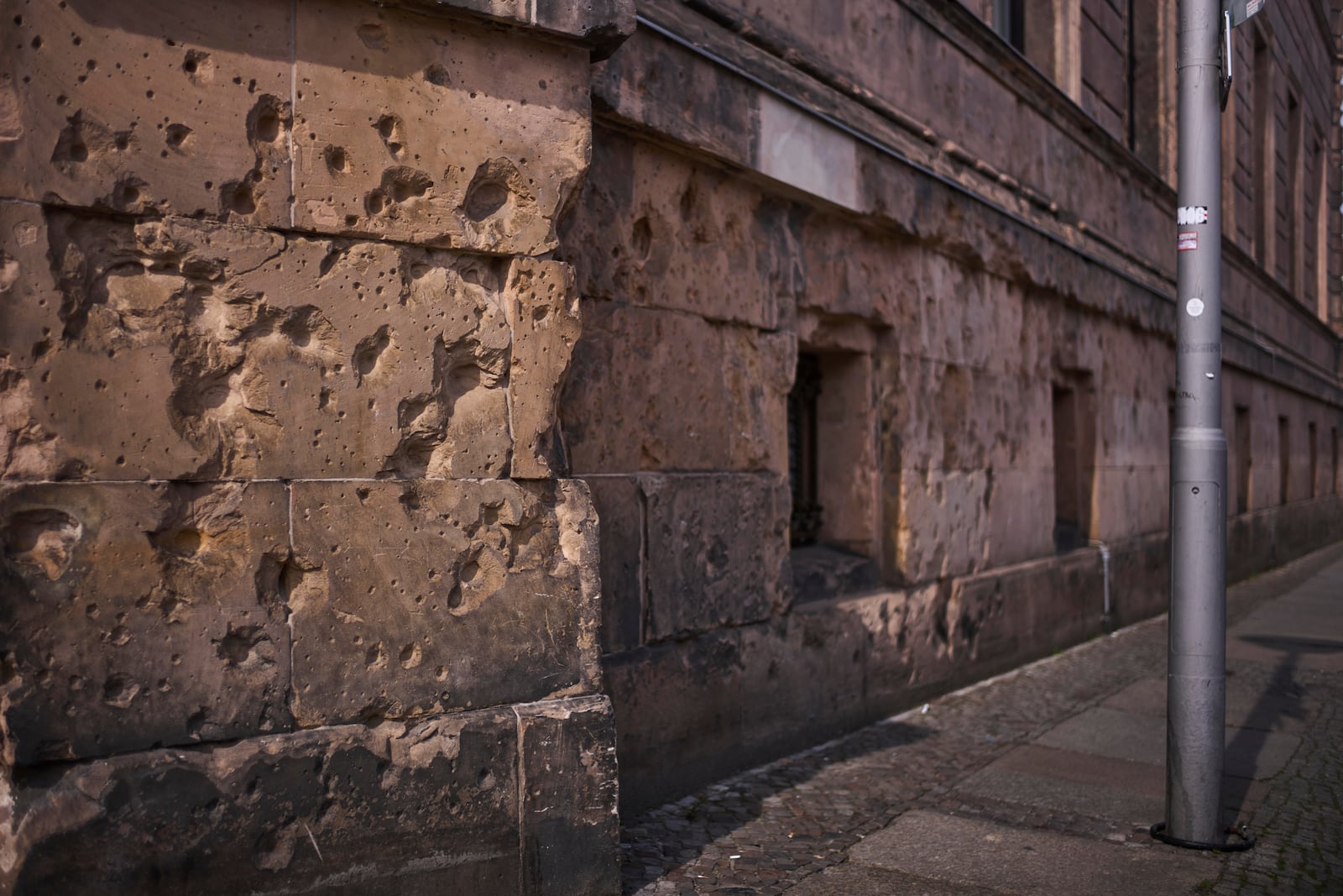 Eighty years after the end of World War II, holes from artillery fire are still visible on the facade of a house in the city center of Berlin, Germany, Friday, May 2, 2025. (AP Photo/Markus Schreiber)