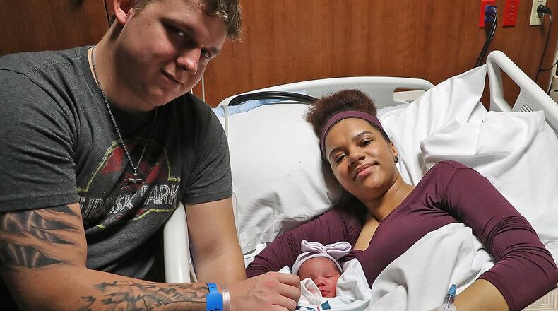 Austin Pratt, 24, and Brianna Miller, 24, with their new baby girl, Ellamae Rose Pratt. Ellamae is the first baby born in Clark County this year, arriving at 5:35 pm. BILL LACKEY/STAFF