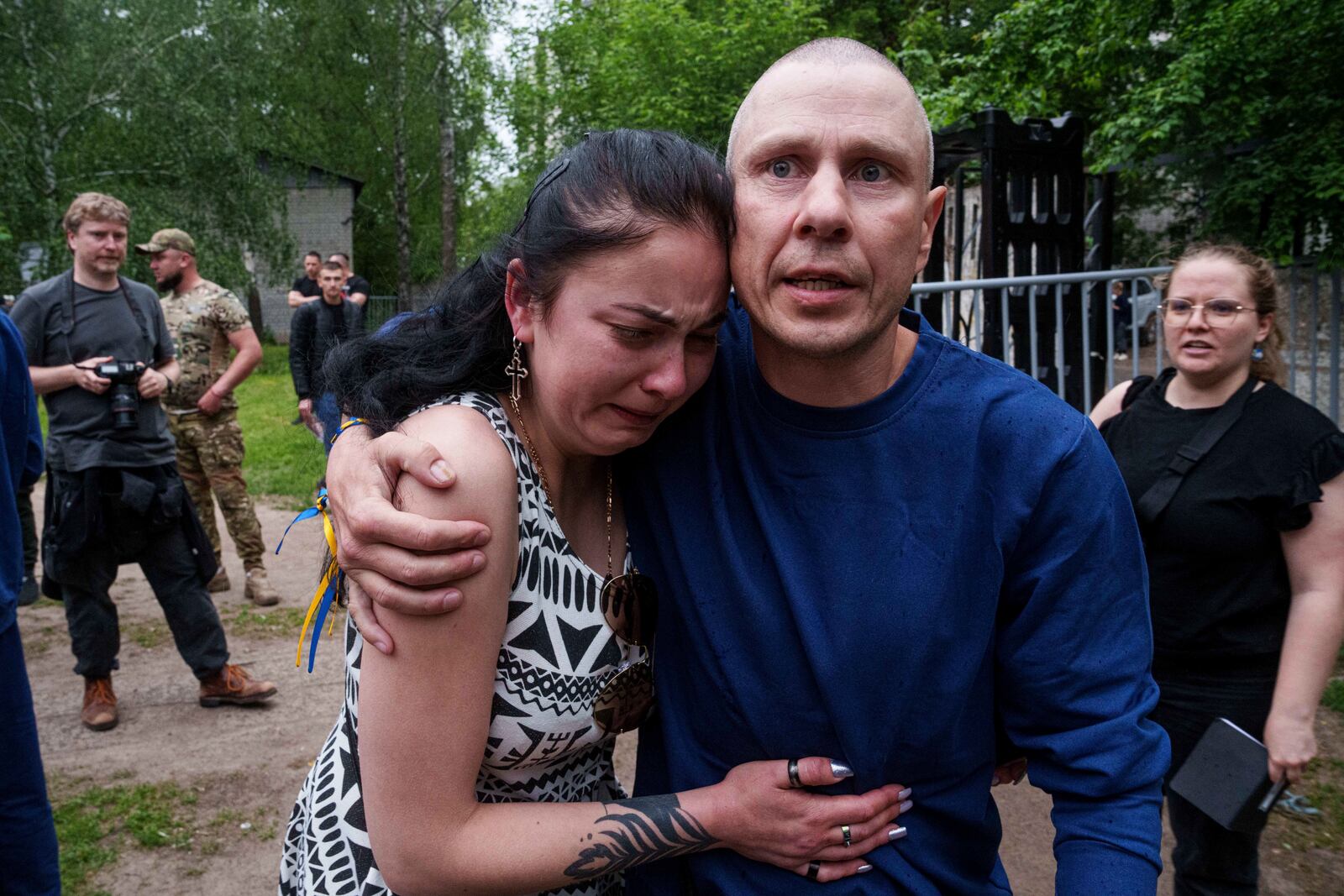 A Ukrainian soldier hugs a woman after returning from captivity during a POWs exchange between Russia and Ukraine, in Chernyhiv region, Ukraine, Saturday, May 24, 2025. (AP Photo/Evgeniy Maloletka)