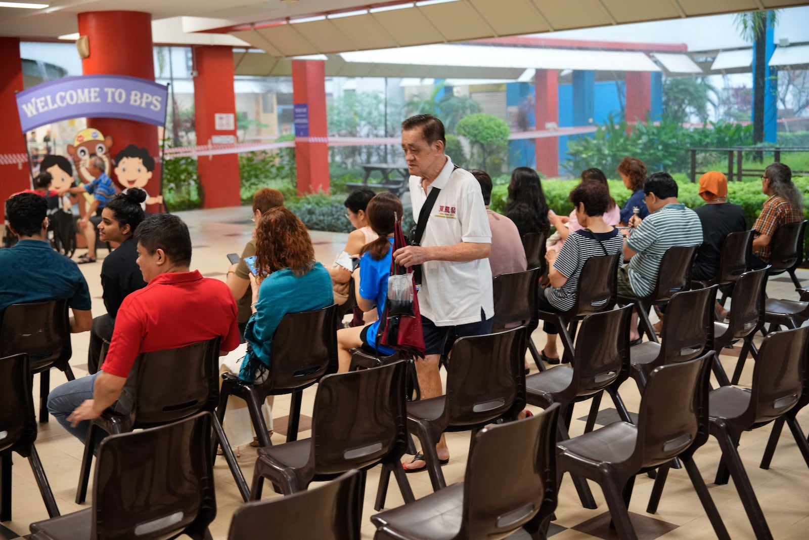 Singaporean voters arrives at a voting station to cast their vote for general election in Singapore, Saturday, May 3, 2025. (AP Photo/Vincent Thian)