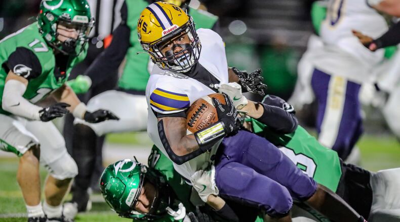 Springfield High School junior running back Deontre Long is tackled by multiple Northmont defenders during their game on Thursday night at Premier Health Stadium. Springfield won 48-7. Michael Cooper/CONTRIBUTED