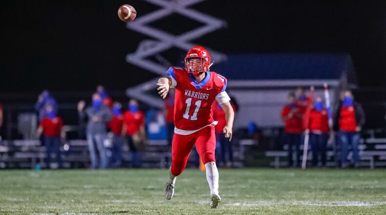 Action cutline: Northwestern High School quarterback Brock Mansfield throws the ball during their game against Indian Lake last season at Taylor Field in Springfield. CONTRIBUTED PHOTO BY MICHAEL COOPER