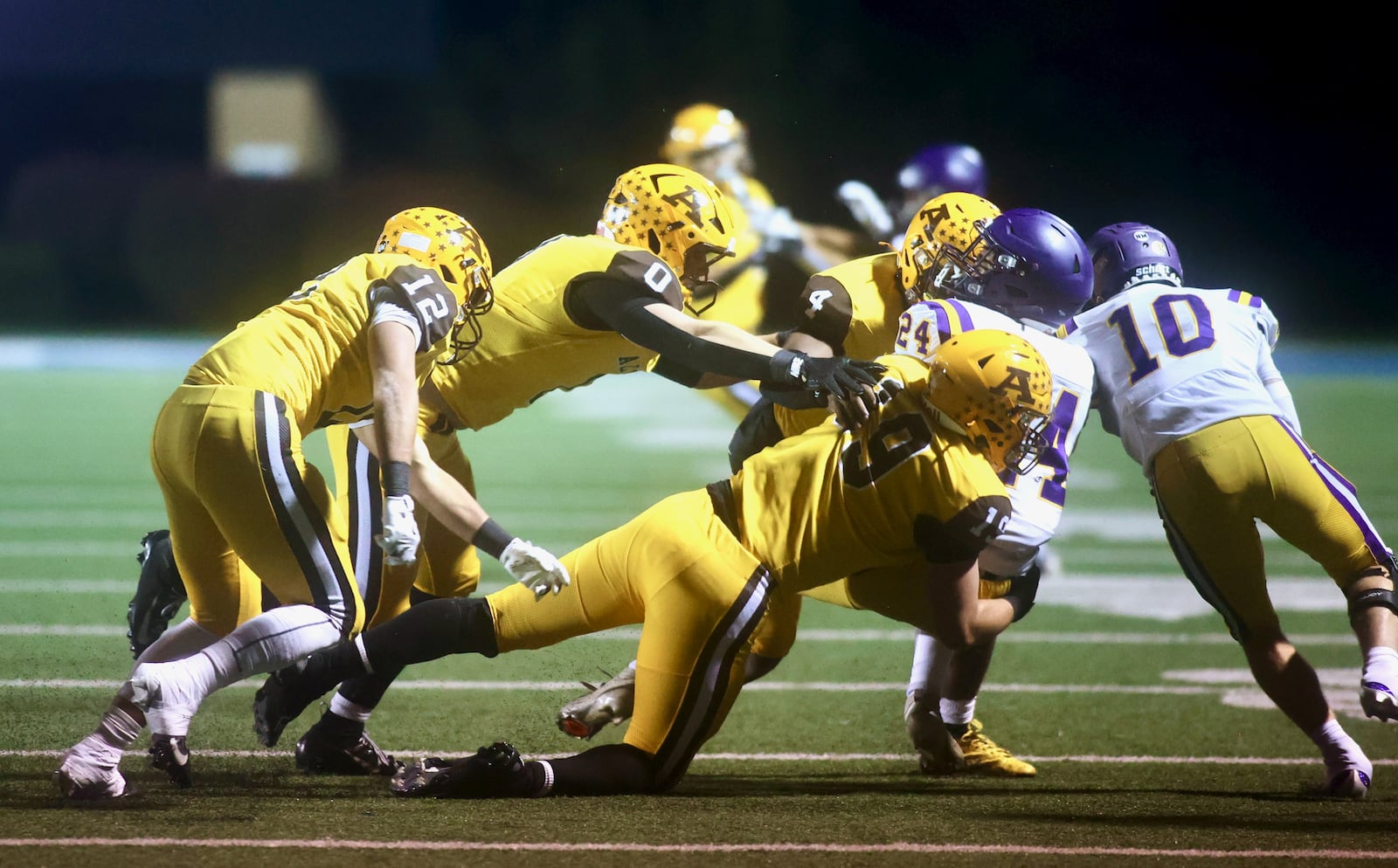 Alter's Wyatt Reifschneider tackles Bellbrook's Christian Burchfield in the first round of the Division III, Region 12 playoffs on Friday, Oct. 31, 2025, at Roush Stadium in Kettering. David Jablonski/Staff