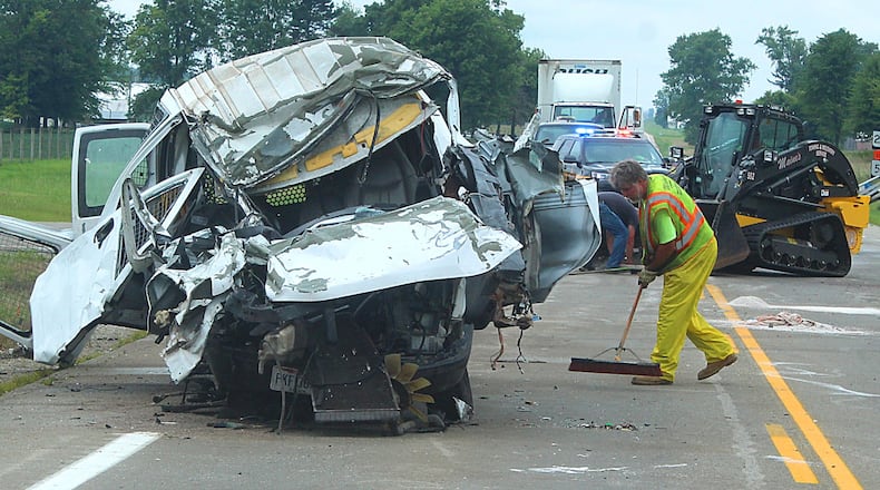 A worker clears debris from a double fatal on Ohio 235 in Champaign County. JEFF GUERINI/STAFF