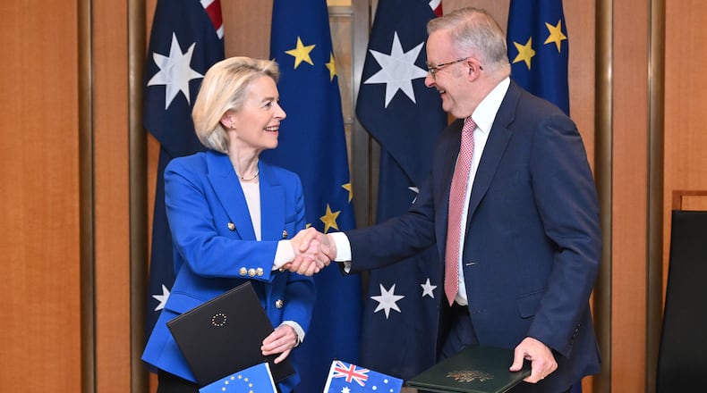 European Commission President Ursula von der Leyen, left, and Australian Prime Minister Anthony Albanese shake hands after signing a joint statement during a ceremony at Parliament House in Canberra, Tuesday, March 24, 2026. (Lukas Coch/AAP Image via AP)