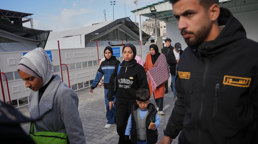 Palestinians patients and their relatives gather to board a bus in Khan Younis before they head to the Rafah crossing, leaving the Gaza Strip for medical treatment abroad, Wednesday, Feb. 4, 2026. (AP Photo/Abdel Kareem Hana)