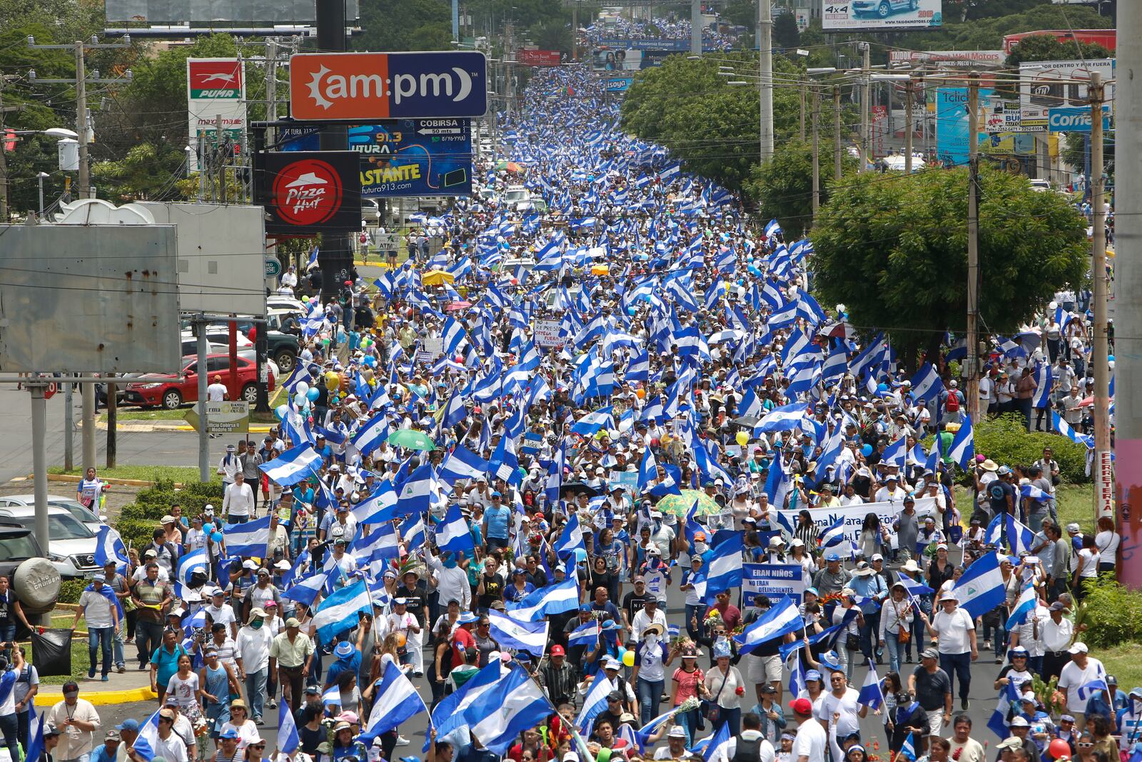 FILE - Hundreds of thousands participate in a demonstration called the "March of the Flowers" remembering the children killed during the last two-months of protests, in Managua, Nicaragua, on June 30, 2018. (AP Photo/Alfredo Zuniga, File)