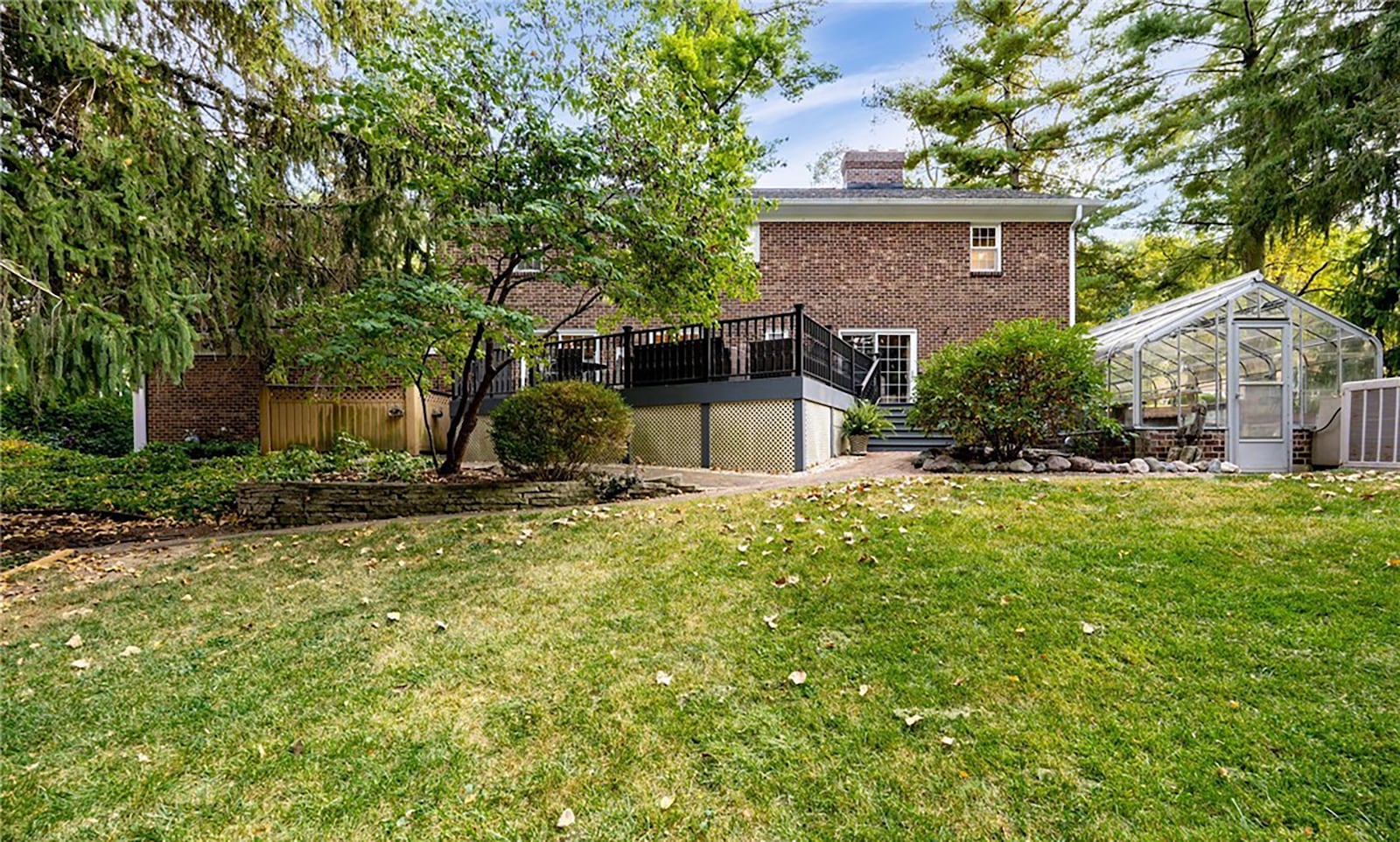 The rear of the home has a wood deck, greenhouse, three season gazebo and firepit area. CONTRIBUTED