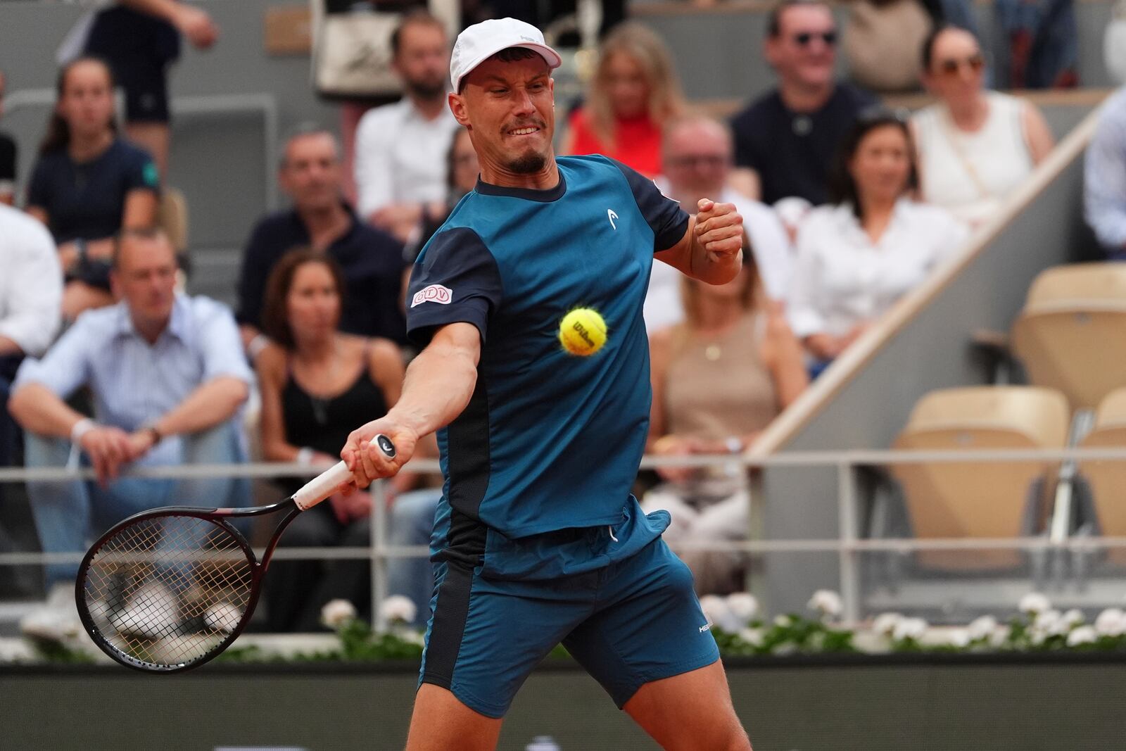 Austria's Filip Misolic returns the ball to Serbia's Novak Djokovic during their third round match of the French Tennis Open, at the Roland-Garros stadium, in Paris, Saturday, May 31, 2025. (AP Photo/Lindsey Wasson)