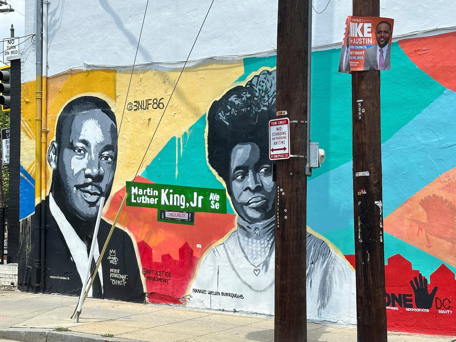 A campaign sign for a city council candidate is pictured on display in front of a mural of Martin Luther King Jr. and Nannie Helen Burroughs in the Anacostia neighborhood of southeast Washington, Wednesday, July 9, 2025. (AP Photo/Robert Yoon)