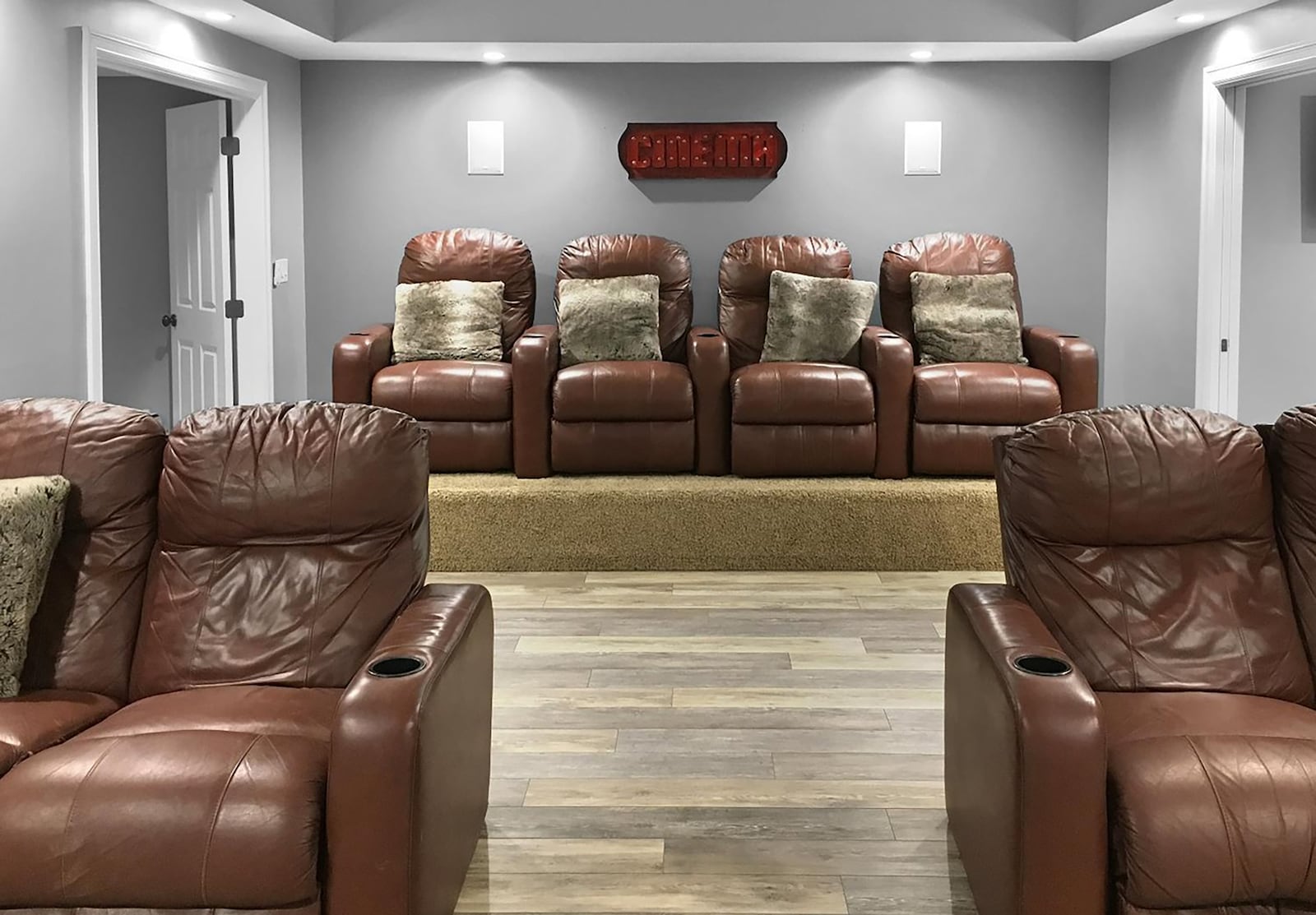 The state of the art theater room in the finished basement has two levels of seating, one with LVT flooring and the other with carpeting. There is a drop down screen and built in cabinets. CONTRIBUTED