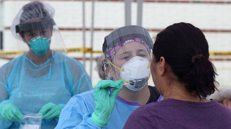 A woman has a COVID-19 test Wednesday at the Clark County Combined Health District’s free COVID testing clinic at Hayward Middle School. BILL LACKEY/STAFF
