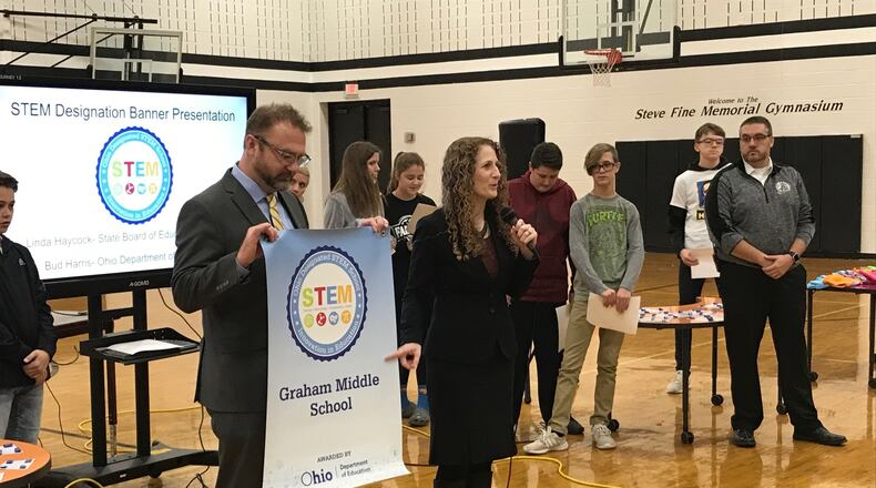 Linda Haycock, Ohio Board of Education Member, presents a STEM award to Graham Local Schools for developing and excellence in Science, Technology, Engineering, and Mathematics curriculum. ERIC HIGGENBOTHAM/STAFF