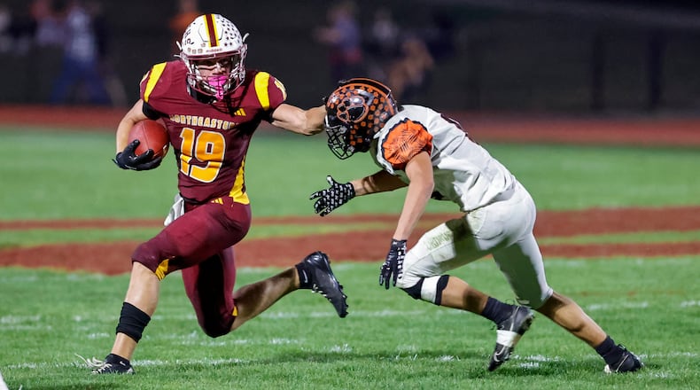 Northeastern High School senior Jacoby Newman stiff arms a West Liberty-Salem defender during their game Friday, Oct. 3 at Conover Stadium in Springfield. The Jets won 27-24. MICHAEL COOPER / STAFF