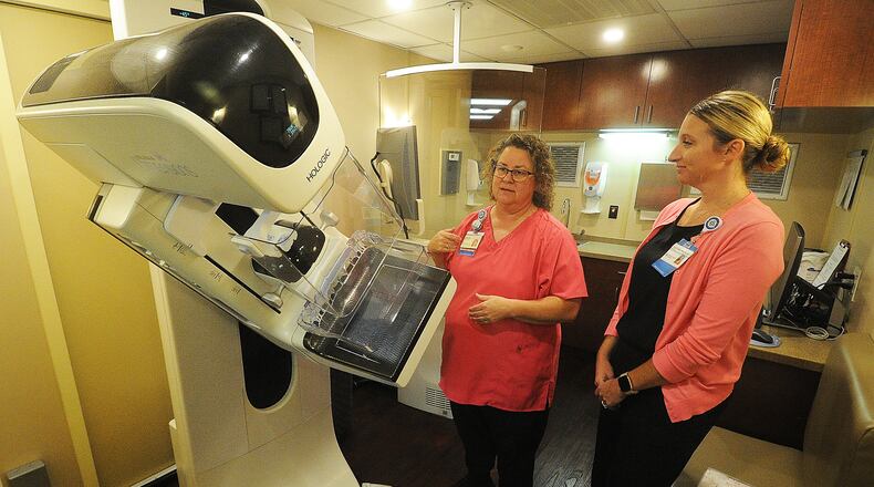 Shelly Robinson, mammographer for Premier Health mobile mammography coach, left, and Tracy Short, director of Premier Health's ambulatory imaging center, talk about the importance of Breast Cancer Awareness. MARSHALL GORBY\STAFF
