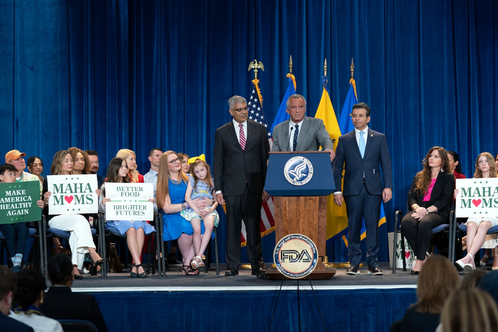 Health and Human Services Secretary Robert F. Kennedy Jr. flanked by Director of the National Institutes of Health Jay Bhattacharya, left, and Food and Drug Administration (FDA) commissioner Marty Makary, right, speaks during a news conference on the FDA's intent to phase out the use of petroleum-based synthetic dyes in the nation's food supply at the Hubert Humphrey Building Auditorium in Washington, Tuesday, April 22, 2025. (AP Photo/Jose Luis Magana)