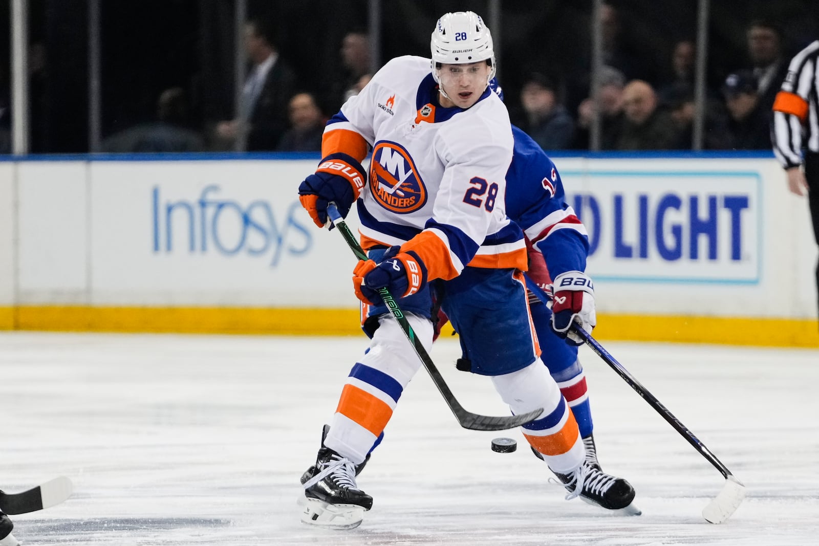 FILE - New York Islanders' Alexander Romanov (28) tries to control the puck during the first period of an NHL hockey game against the New York Rangers, March 3, 2025, in New York. (AP Photo/Frank Franklin II, file)