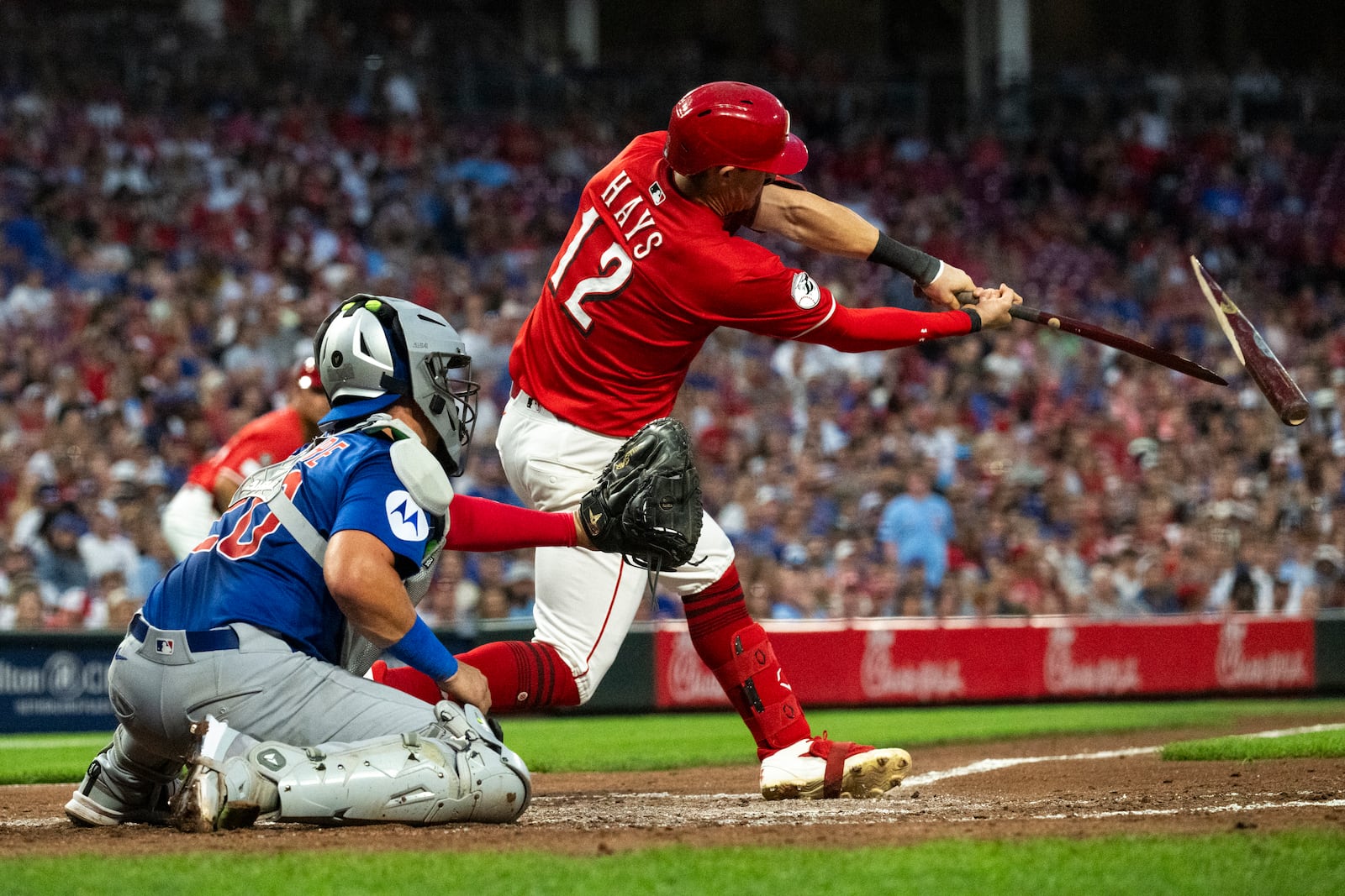 Cincinnati Reds' Austin Hays (12) breaks his bat while connecting with a pitch in the third inning of a baseball game against the Chicago Cubs, Saturday, Sept. 20, 2025, in Cincinnati. (AP Photo/Michael Swensen)