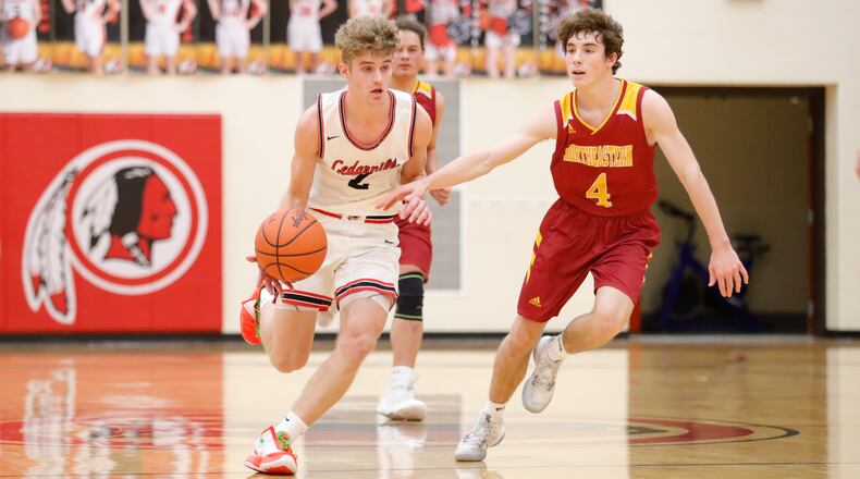 Cedarville High School senior Trent Koning drives past Northeastern's Sam Franzen during their game on Tuesday night in Cedarville. CONTRIBUTED PHOTO BY MICHAEL COOPER