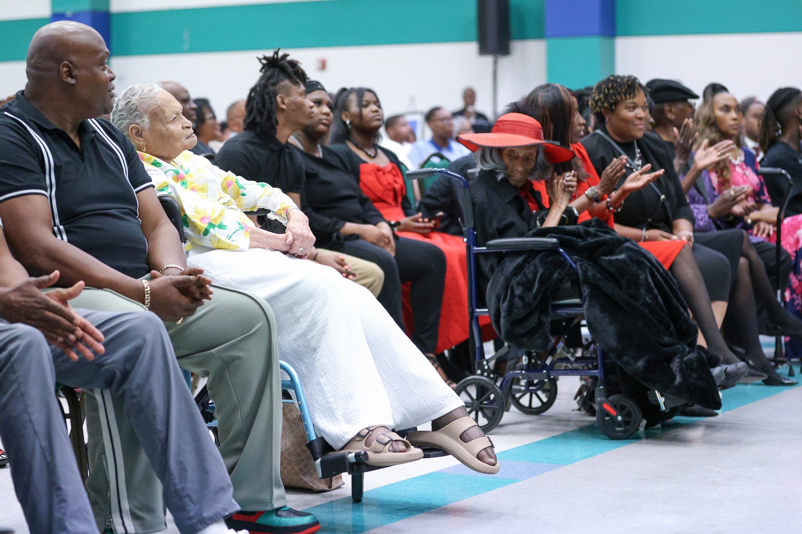 Viola "Mother" Ford Fletcher, 110 years of age (yellow) is one of the final two survivors sits across the aisle from the other survivor Lessie Benningfield "Mother" Randle (red hat), 109 years old, as they listen during the Legacy event for the Tulsa Race Massacre on Sunday, June 1, 2025, at Greenwood Cultural Center in Tulsa, Okla. (AP Photo/Joey Johnson)