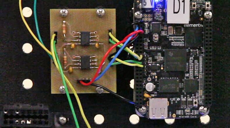 Graduate student Capt. Eddie Caberto uses a driving simulation game and automobile network parts to research hacking vulnerabilities at the Air Force Institute of Technology Center for Cyber Research at Wright-Patterson Air Force Base. TY GREENLEES / STAFF