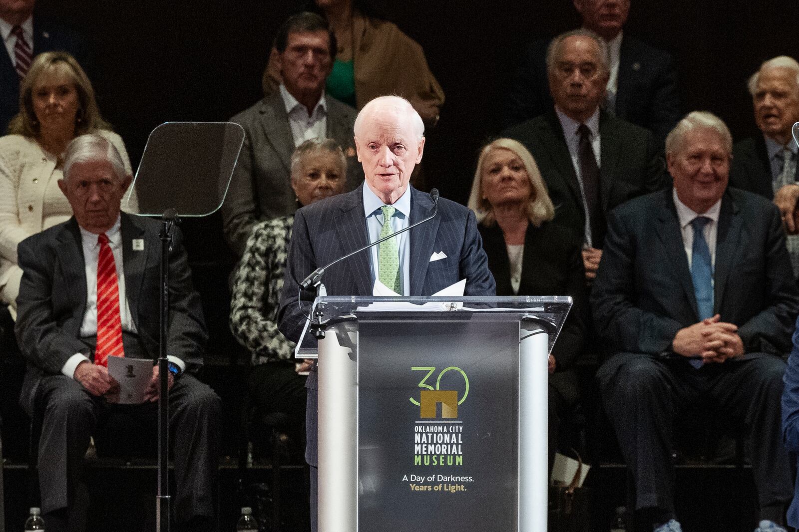 Former Oklahoma Governor Frank Keating speaks to guest during the 30th anniversary memorial service for the victims of the 1995 Oklahoma City bombing, in Oklahoma City, Saturday, April 19, 2025. (AP Photo/Alonzo Adams)
