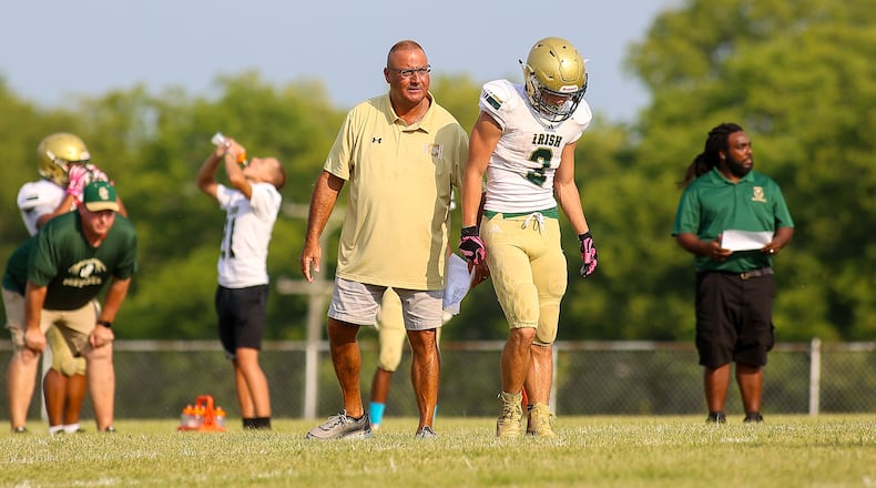Catholic Central High School coach Jim Dimitroff talks with Ashton Young during their scrimmage game at Bradford last season. Dimitroff, a 1975 Central grad, was recently named the Irish's head football coach. CONTRIBUTED PHOTO BY MICHAEL COOPER
