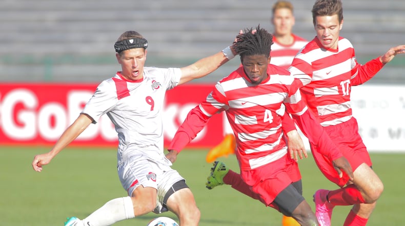 Ohio State's Danny Jenson, left, scores the game-tying goal in the second half as Dayton's Lalas Abubakar defends in the second round of the NCAA tournament on Sunday, Nov. 22, 2015, at Jesse Owens Memorial Stadium in Columbus. David Jablonski/Staff
