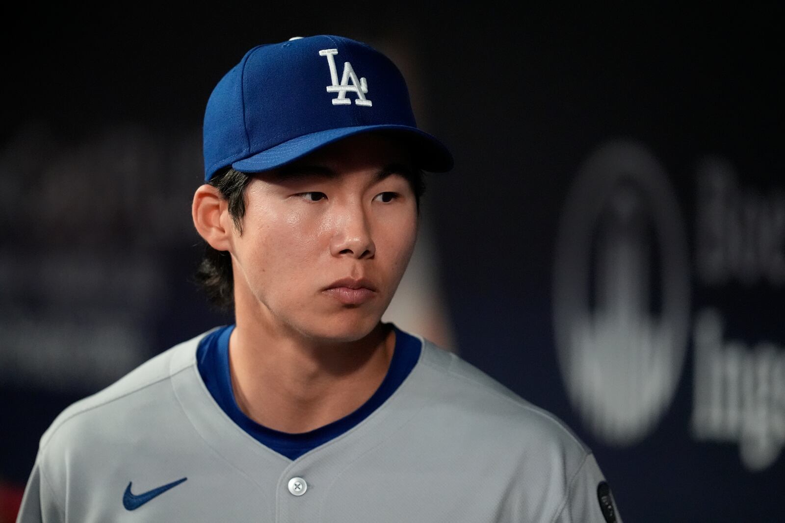 Los Angeles Dodgers' Hyeseong Kim stands in the dugout in the ninth inning of a baseball game against the Atlanta Braves, Sunday, May 4, 2025, in Atlanta. (AP Photo/Mike Stewart)